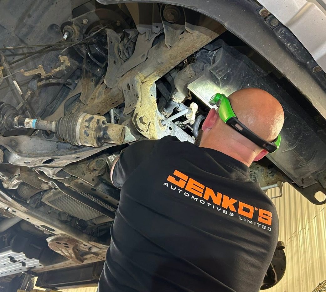 Jenko's technician working underneath a vehicle
